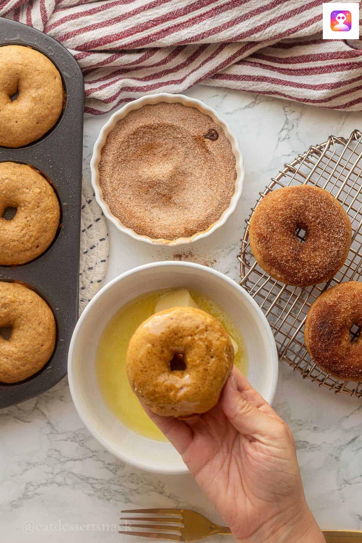 Dipping donuts in butter and sugar.